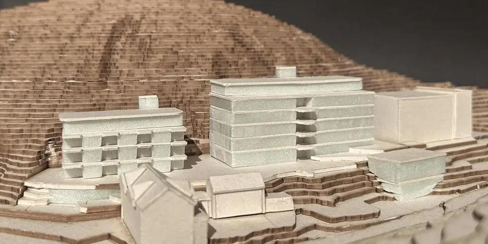 Architekturmodell eines modernen Pflegeheim-Gebäudes mit Terrassenstruktur vor einem modellierten Hang